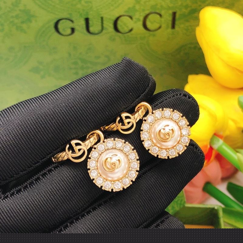 G*u*i earrings